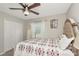 Comfortable bedroom with a cozy bed, ceiling fan, and closet at 7019 Wiseman Run Dr, Sun City Center, FL 33573