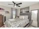 This comfortable bedroom has a ceiling fan, large framed mirror, and a full sized bed with soft bedding at 7019 Wiseman Run Dr, Sun City Center, FL 33573
