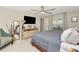 This comfortable bedroom has a ceiling fan, large mirror, dresser and a full sized bed with soft bedding at 7019 Wiseman Run Dr, Sun City Center, FL 33573