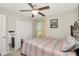 This bedroom features a ceiling fan, closet, and a framed mirror in the corner of the room at 7019 Wiseman Run Dr, Sun City Center, FL 33573