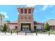 Stunning community entrance with stone facade, well-manicured landscaping, and gate access, ensuring privacy at 7019 Wiseman Run Dr, Sun City Center, FL 33573
