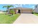 Charming single-Gathering home with a well-manicured lawn and a two-car garage at 7019 Wiseman Run Dr, Sun City Center, FL 33573