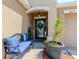Cozy front porch with comfortable seating and decorative plants at 7019 Wiseman Run Dr, Sun City Center, FL 33573