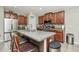 Kitchen with a center island, stainless steel appliances, and ample cabinet space for storage and meal preparation at 7019 Wiseman Run Dr, Sun City Center, FL 33573