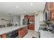 Bright kitchen featuring stainless steel appliances, granite countertops, and an open layout into the living area at 7019 Wiseman Run Dr, Sun City Center, FL 33573