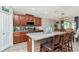 Kitchen island with granite counters, stainless steel appliances and bar stool seating at 7019 Wiseman Run Dr, Sun City Center, FL 33573