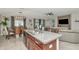 Open kitchen with a granite island, stainless steel dishwasher, and adjacent dining area at 7019 Wiseman Run Dr, Sun City Center, FL 33573