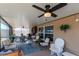 Covered lanai with comfortable seating area, ceiling fan, and view of the fenced backyard at 7019 Wiseman Run Dr, Sun City Center, FL 33573