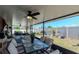 Covered lanai featuring outdoor seating, a ceiling fan, and a view of the backyard with a firepit at 7019 Wiseman Run Dr, Sun City Center, FL 33573