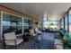 Screened lanai with ceiling fan, comfortable seating, and view of the backyard at 7019 Wiseman Run Dr, Sun City Center, FL 33573