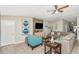 Comfortable living room featuring a stylish sofa, accent chair, and entertainment center with a mounted television at 7019 Wiseman Run Dr, Sun City Center, FL 33573