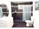 Modern bathroom featuring a black tile shower and an updated vanity with a stylish oval mirror at 7040 Lumberton Rd, Zephyrhills, FL 33540