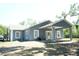 Charming single-story home featuring a covered carport and neutral blue-gray paint scheme at 7040 Lumberton Rd, Zephyrhills, FL 33540