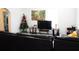 Spacious living room with dark sofa, a decorative tiger wall hanging and a Christmas tree at 7040 Lumberton Rd, Zephyrhills, FL 33540