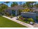 Stunning aerial view of a beautifully landscaped home with a lush green lawn and a charming gated entrance at 720 Brightwaters Ne Blvd, St Petersburg, FL 33704
