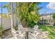 Private backyard seating area with table, chairs, and lush landscaping at 720 Brightwaters Ne Blvd, St Petersburg, FL 33704