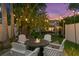 Cozy backyard seating area with a fire pit and string lights for evening gatherings at 720 Brightwaters Ne Blvd, St Petersburg, FL 33704