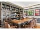 Custom bar area with a wooden bar, glass shelving, and seating for entertaining guests at 720 Brightwaters Ne Blvd, St Petersburg, FL 33704