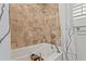 Elegant soaking tub with decorative tile surround and brushed nickel fixtures at 720 Brightwaters Ne Blvd, St Petersburg, FL 33704