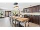 Spacious dining room features modern lighting, stylish décor, and backyard access through french doors at 720 Brightwaters Ne Blvd, St Petersburg, FL 33704