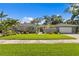 Beautiful home exterior with a well-manicured lawn, lush landscaping, and a charming front entrance at 720 Brightwaters Ne Blvd, St Petersburg, FL 33704