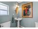 Stylish half bathroom with vintage decor and a charming pedestal sink, offering a touch of elegance at 720 Brightwaters Ne Blvd, St Petersburg, FL 33704