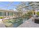 Relaxing screened pool area with covered outdoor bar and lounge seating at 720 Brightwaters Ne Blvd, St Petersburg, FL 33704