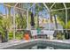 Relaxing poolside lounge area with comfortable seating and tropical plants, ideal for enjoying the outdoors at 720 Brightwaters Ne Blvd, St Petersburg, FL 33704