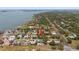 Enchanting aerial view of a neighborhood by the water showcasing houses and mature trees at 7909 Garden N Dr, St Petersburg, FL 33710