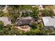 Stunning aerial view of home with lush landscaping, tile roof, and charming front courtyard at 7909 Garden N Dr, St Petersburg, FL 33710