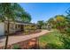 Beautiful backyard with brick walkway, lush landscaping, and well-maintained lawn at 7909 Garden N Dr, St Petersburg, FL 33710