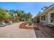 Expansive backyard with seating area, lush landscaping, and a charming shed at 7909 Garden N Dr, St Petersburg, FL 33710