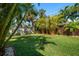 Lush backyard featuring a bamboo fence, tropical foliage, and shade from mature trees at 7909 Garden N Dr, St Petersburg, FL 33710