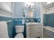 Vintage bathroom featuring blue tiling, a white vanity, and a classic bathtub at 7909 Garden N Dr, St Petersburg, FL 33710