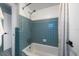 Tiled bathroom with a shower-tub combination and classic fixtures at 7909 Garden N Dr, St Petersburg, FL 33710