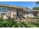 Inviting front porch with seating, plants and manicured landscaping at 7909 Garden N Dr, St Petersburg, FL 33710