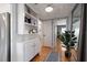 Hallway with hardwood floors, built in bookcase, modern mirror, and stylish decor at 7909 Garden N Dr, St Petersburg, FL 33710