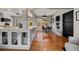 Eat-in kitchen featuring white cabinets, quartz countertops, wine rack, and adjacent dining area at 7909 Garden N Dr, St Petersburg, FL 33710