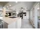 Bright kitchen with white cabinets, stainless appliances, and an island cooktop at 7909 Garden N Dr, St Petersburg, FL 33710
