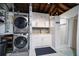 Basement Laundry room featuring modern appliances, bright cabinets, and a tiled shower at 7909 Garden N Dr, St Petersburg, FL 33710
