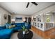 Open-concept living room with a blue velvet sectional and views of the kitchen at 7909 Garden N Dr, St Petersburg, FL 33710
