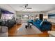 Bright living room with hardwood floors and a comfortable blue sectional sofa at 7909 Garden N Dr, St Petersburg, FL 33710
