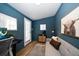 Cozy shed interior with modern desk, stylish sofa, and blue walls at 7909 Garden N Dr, St Petersburg, FL 33710