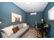 Comfortable shed interior featuring a gray sofa, desk, and modern decor at 7909 Garden N Dr, St Petersburg, FL 33710