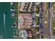Stunning aerial view of waterfront homes with private docks and a luxurious swimming pool at 830 Pinellas Bayway S, St Petersburg, FL 33715
