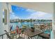 The balcony features a water view with dock, furniture, and an awning at 830 Pinellas Bayway S, St Petersburg, FL 33715
