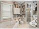 Spacious bathroom featuring a tub, shower, and plenty of decorative wall art at 830 Pinellas Bayway S, St Petersburg, FL 33715