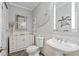 Bright bathroom featuring gray walls, a white vanity, nautical decor, and decorative seashell accents at 830 Pinellas Bayway S, St Petersburg, FL 33715