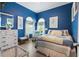 Tranquil blue bedroom with a comfortable bed, arched windows and a relaxing atmosphere at 830 Pinellas Bayway S, St Petersburg, FL 33715
