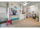 Cozy bonus room featuring neutral walls, a ceiling fan, and fun decorations at 830 Pinellas Bayway S, St Petersburg, FL 33715